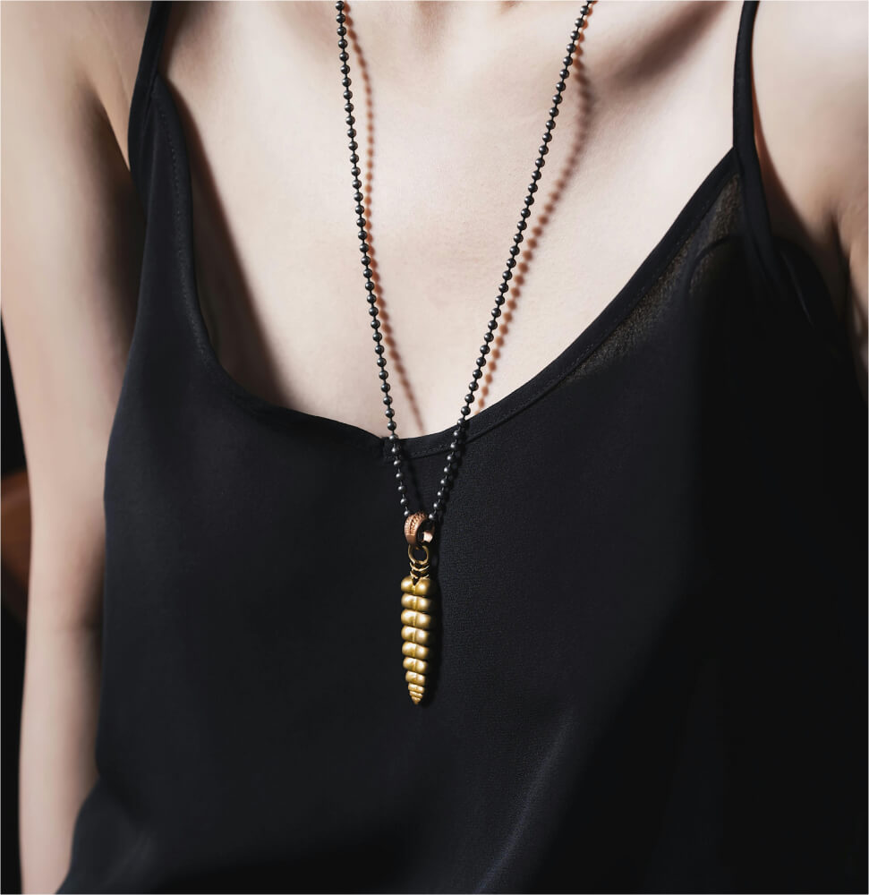 Gold seed pod pendant on a long beaded chain