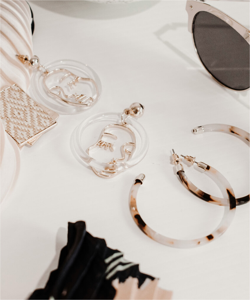 Statement acrylic face earrings and tortoiseshell hoops