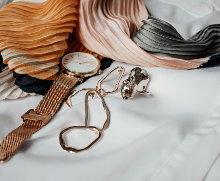 Rose gold watch, organic hoop earrings and a crystal ring