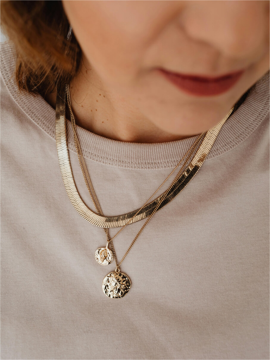 Layered gold herringbone chain with two hammered coin pendants