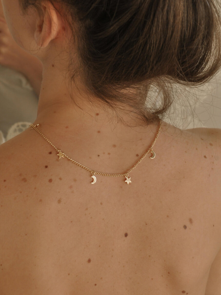 Gold choker hung with alternating star and crescent moon charms